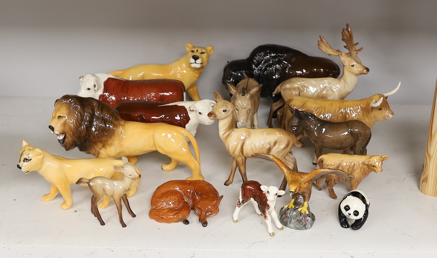 A selection of Beswick animals, to include four bulls and two calves, stag, deer, fawn, fox, panda, falcon, donkey, foal, lioness, lion, and a lion cub (17)